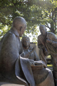 statue of st vincent de paul with two students